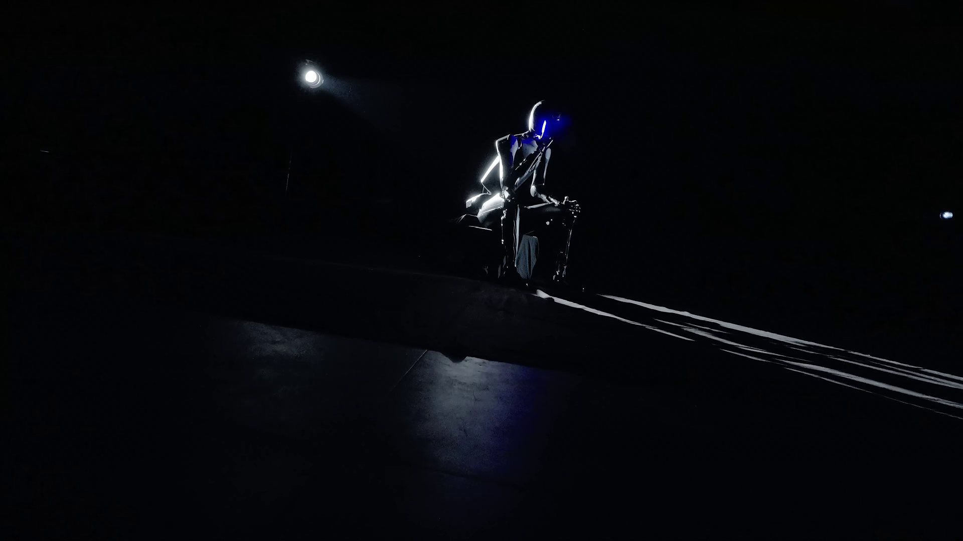 TR-series humanoid robot under a spotlight on a dark stage